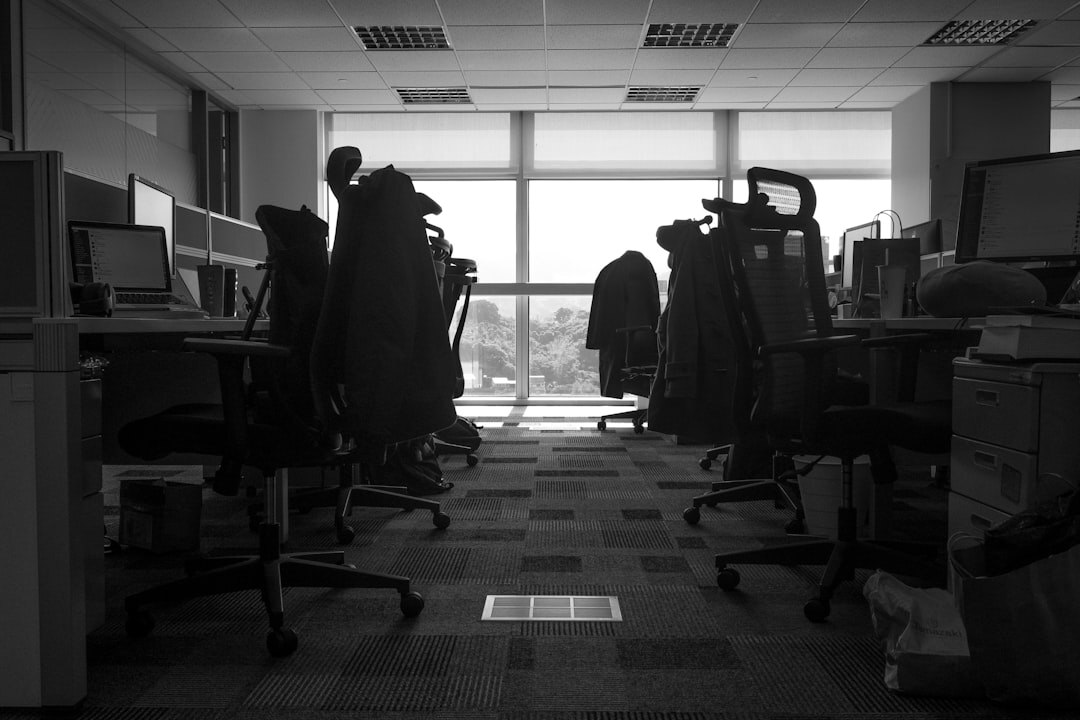 Modern newsroom with journalists working at desks with screens